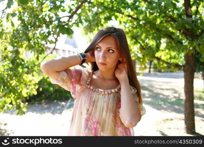 Portrait of a sexy young female in a park in sexy short dress