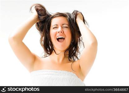 portrait of a shining brunette making face shaking hair and screaming