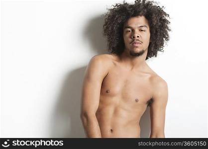 Portrait of a shirtless young man over white background