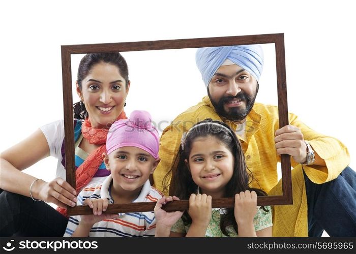 Portrait of a Sikh family through a wooden frame