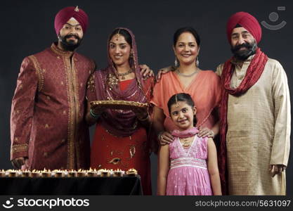 Portrait of a Sikh family with diyas