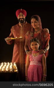 Portrait of a Sikh family with diyas