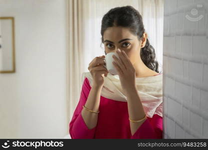 Portrait of a single woman drinking a cup of coffee. 