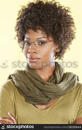 Portrait of a smart African American woman wearing glasses with a stole round her neck over colored background