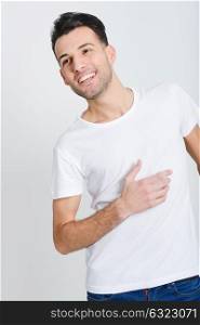 Portrait of a smart smiling young man standing against white background