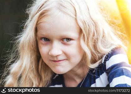 Portrait of a smiling beautiful little blonde girl.