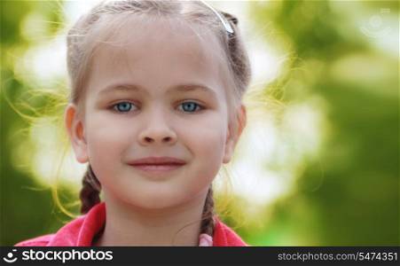 Portrait Of A Smiling Beautiful Little Girl Outdoors In Summer Day