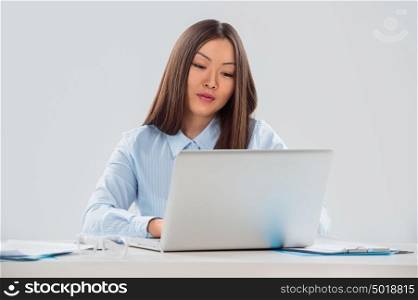 Portrait of a smiling beautiful young business woman working on laptop