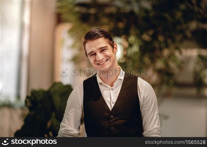 Portrait of a Smiling Caucasian Businessman, Look into the Camera in Comfortable Posture