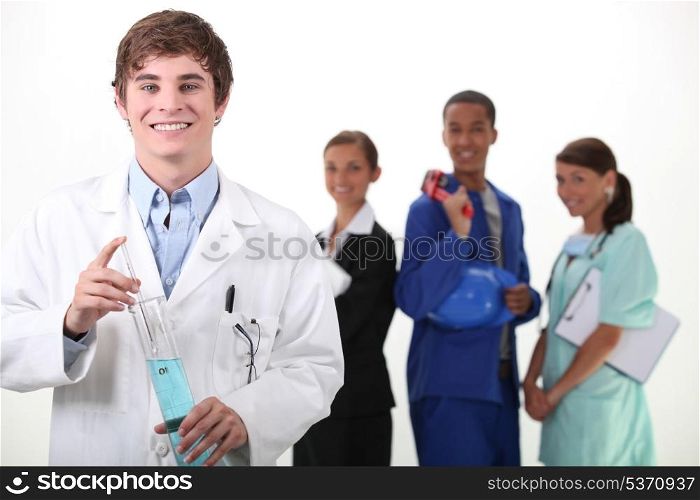Portrait of a smiling chemist and different workers