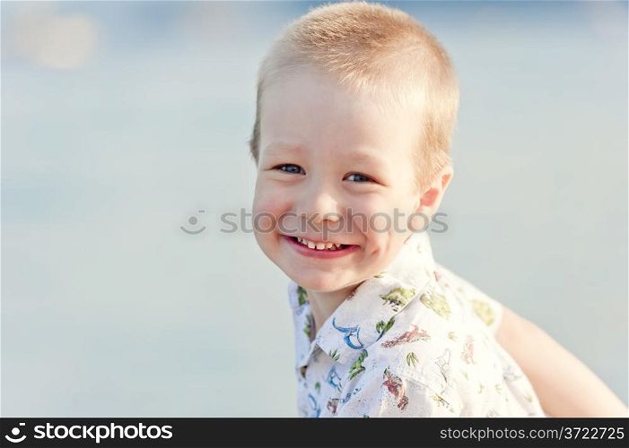 portrait of a smiling child on the background of the sea