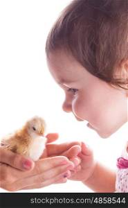 Portrait of a smiling child who is happy seeing little chickens. Close-up. Happy child and little chicken