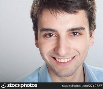 portrait of a smiling handsome trainee starting business career (close-up)