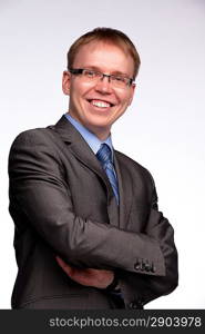 Portrait of a smiling man with crossed arms on glaucous background