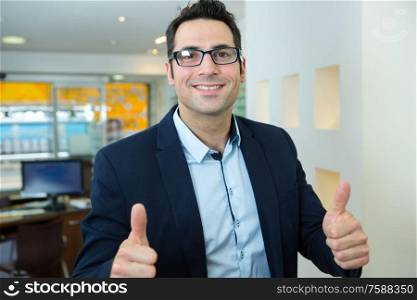 portrait of a smiling photo editor wearing glasses