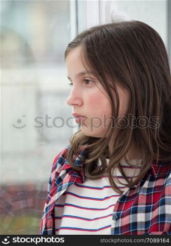 portrait of a smiling young teenage girl with check shirt