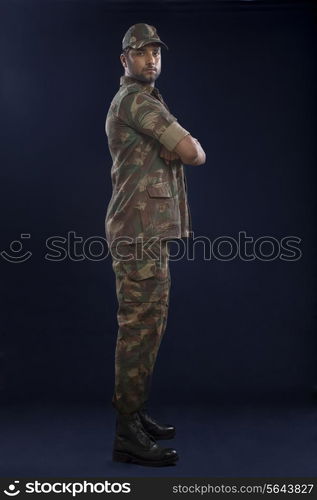 Portrait of a soldier standing with his arms crossed