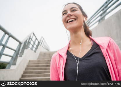 Portrait of a sport woman running on stairs outdoors. Fitness, sport and healthy lifestyle concepts.