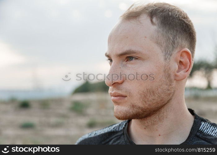 portrait of a sporty young Caucasian guy in a black t-shirt