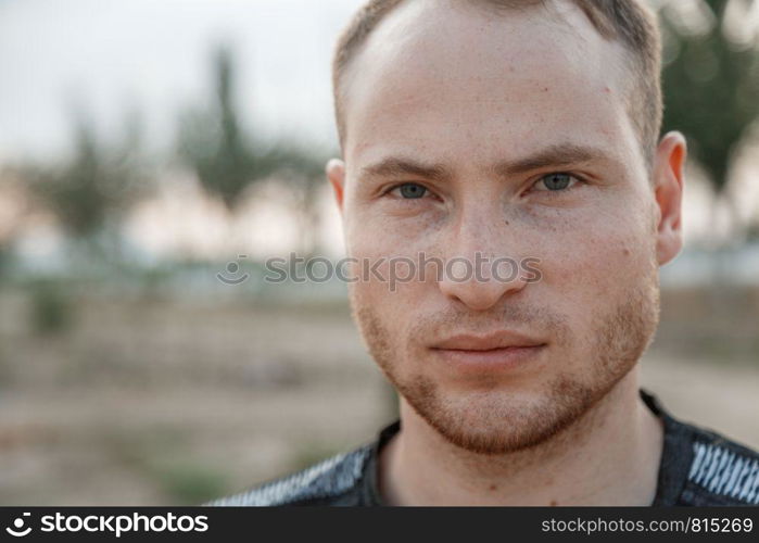 portrait of a sporty young Caucasian guy in a black t-shirt