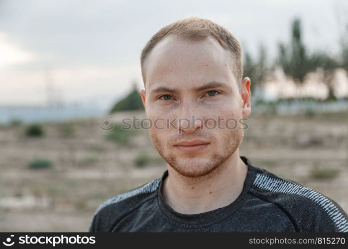 portrait of a sporty young Caucasian guy in a black t-shirt