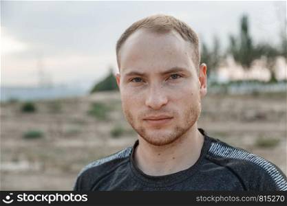 portrait of a sporty young Caucasian guy in a black t-shirt
