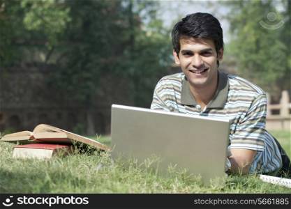 Portrait of a student with a laptop smiling