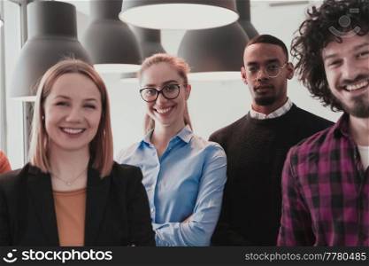 Portrait of a successful creative business team looking at camera and smiling. Diverse business people standing together at startup. Selective focus. High-quality photo. Portrait of successful creative business team looking at camera and smiling. Diverse business people standing together at startup. Selective focus 