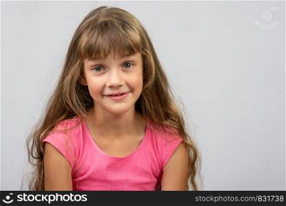 Portrait of a surprised beautiful eight-year cheerful European girl