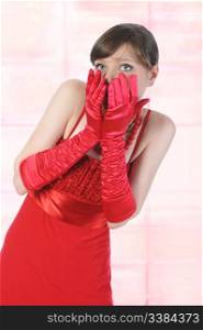 Portrait of a surprised girl in red gloves.