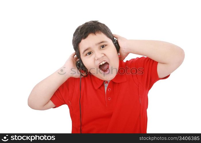 Portrait of a sweet young boy listening to music on headphones against white background