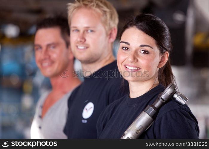 Portrait of a team of mechanics with a woman in the forground
