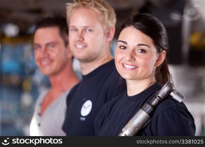 Portrait of a team of mechanics with a woman in the forground
