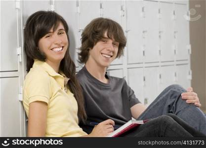 Portrait of a teenage boy and a teenage girl sitting together and smiling