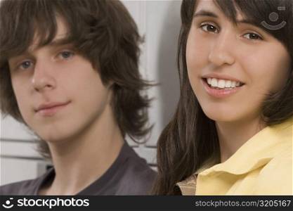 Portrait of a teenage boy and a teenage girl smiling
