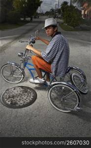 Portrait of a teenage boy cycling on a low rider bicycle