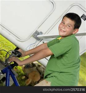 Portrait of a teenage boy riding a bicycle