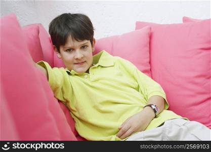 Portrait of a teenage boy sitting on a couch