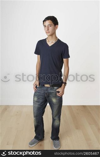 Portrait of a teenage boy standing with his hands in his pockets