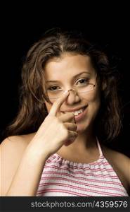 Portrait of a teenage girl adjusting her eyeglasses