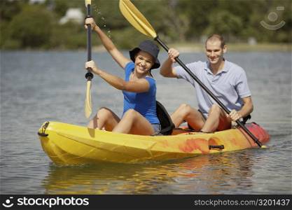 Portrait of a teenage girl and a young man kayaking