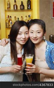 Portrait of a teenage girl and a young woman holding drinks