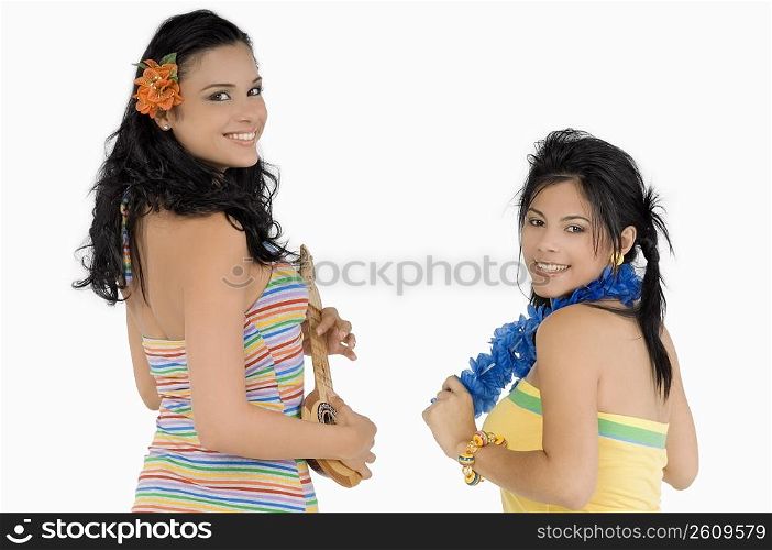 Portrait of a teenage girl and a young woman smiling