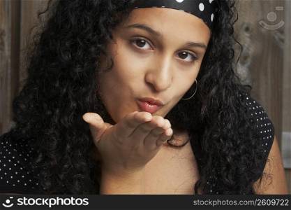 Portrait of a teenage girl blowing a kiss