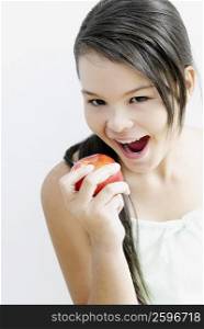Portrait of a teenage girl eating an apple