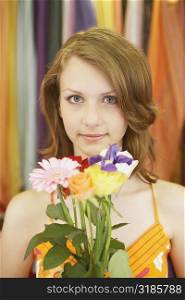 Portrait of a teenage girl holding a bouquet of flowers