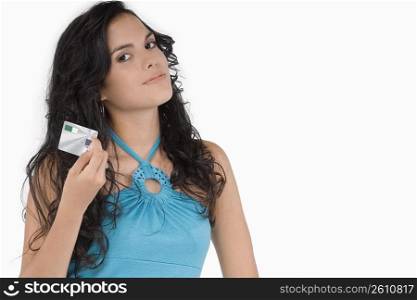 Portrait of a teenage girl holding a credit card