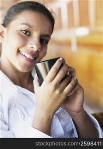 Portrait of a teenage girl holding a cup