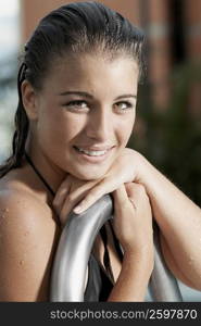 Portrait of a teenage girl holding a metal bar