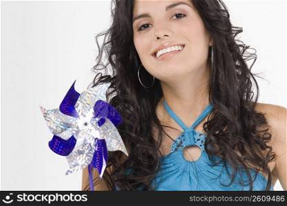 Portrait of a teenage girl holding a pinwheel and smiling